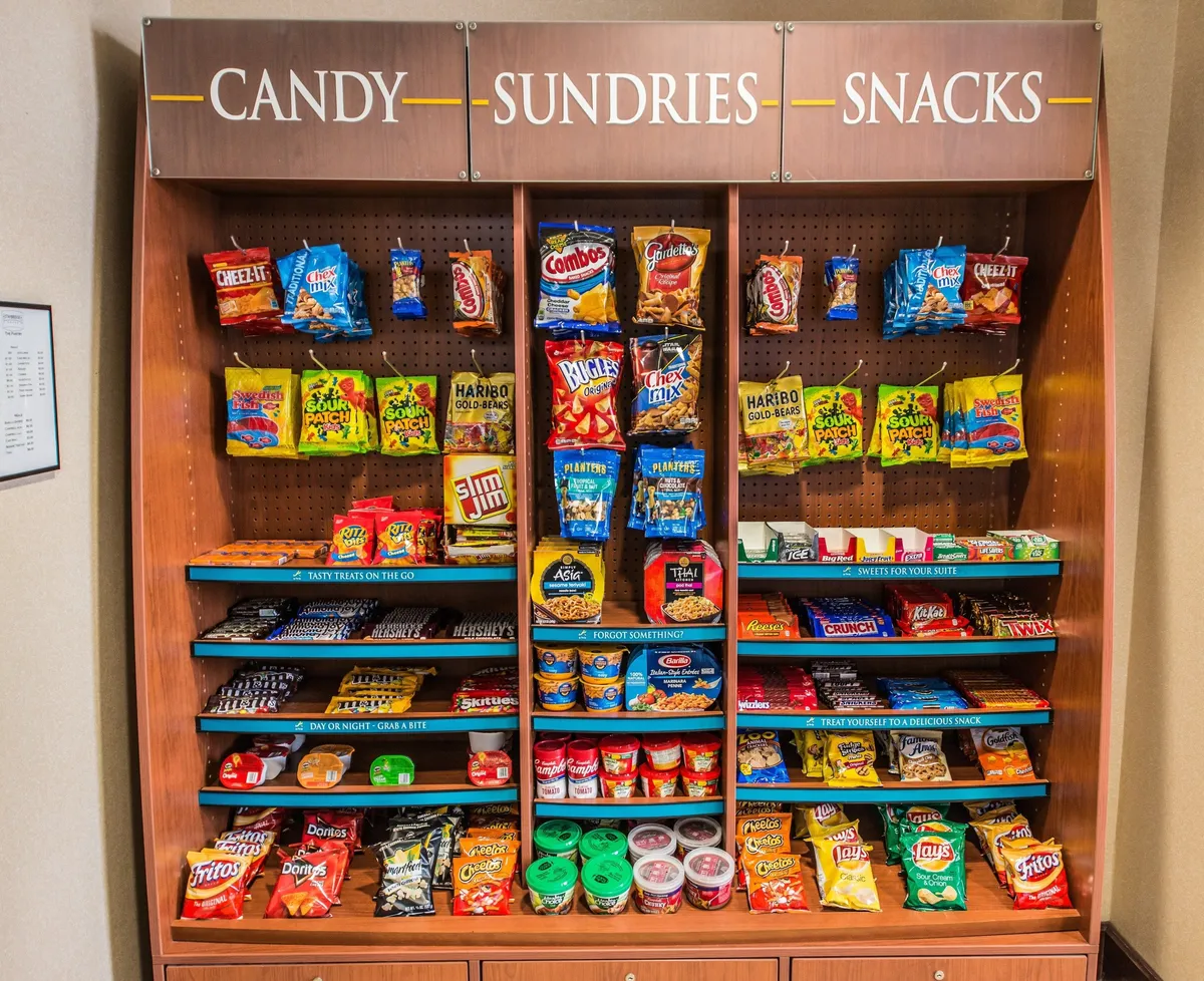 A colorful sundries section brimming with snacks, candy, and essential items. The cheerful display suggests a convenient stop for quick snacks or late-night cravings, catering to busy professionals on the go.